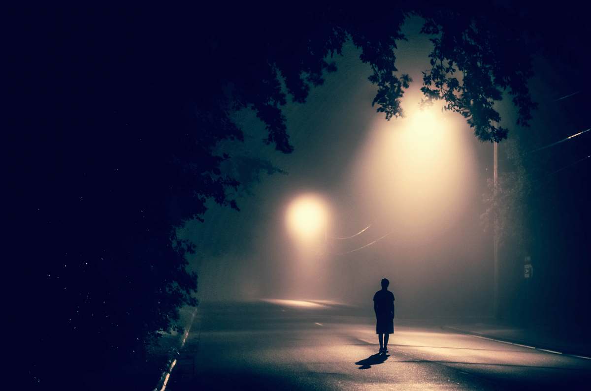 united states silhouette of person standing on concrete road with streetlights turned on during nighttime plymouth